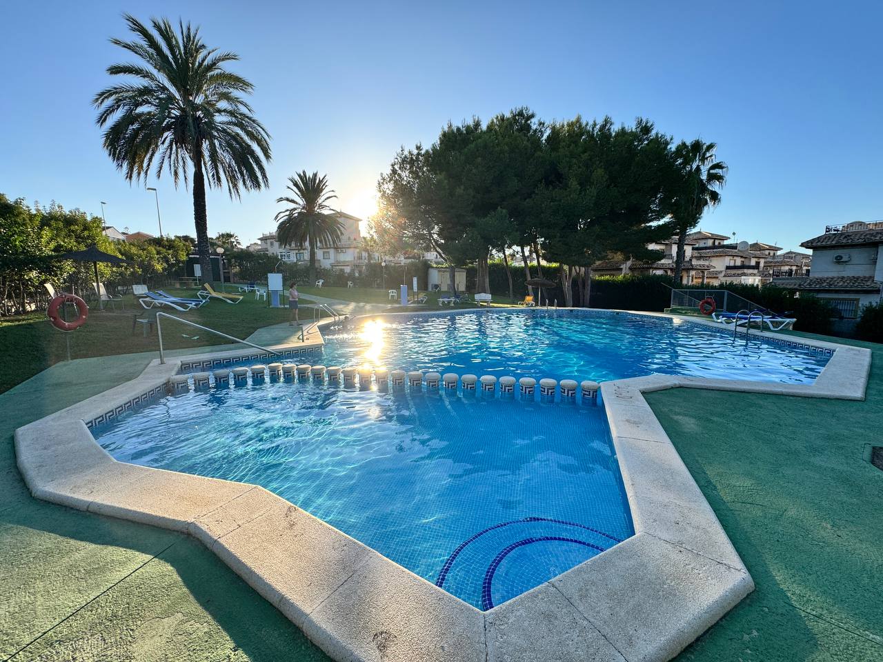 Community swimming pool and landscaped gardens in quiet residential complex
